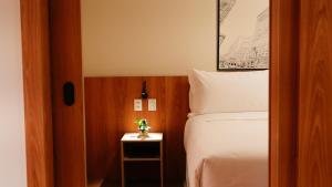 a bedroom with a bed and a table with a plant on it at Soho Plaza Hotel in Brasília
