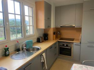a kitchen with a sink and a counter top at apartamentos beach langosteira 2 in Finisterre