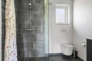 a bathroom with a shower and a toilet at 0370-Romo-Vestergardsvaenget-13 in Høm +39 photos