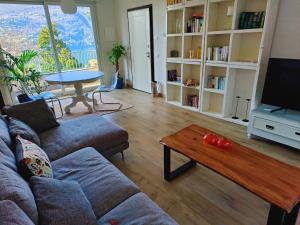 a living room with a couch and a coffee table at Kaspers home lake Como in Blevio