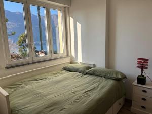 a bed in a bedroom with a window at Kaspers home lake Como in Blevio