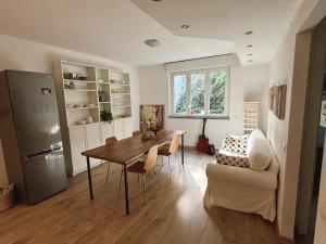 a living room with a table and a chair at Kaspers home lake Como in Blevio