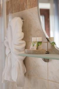 a bathroom with a shelf with towels and a mirror at Hope Nest Pelion in Zagora +84 photos