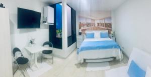 a bedroom with a bed and a table and chairs at Modern apartment/Studio in Pereira