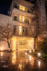 a building at night with lights in a parking lot at Wave Inn boutique in Yerevan