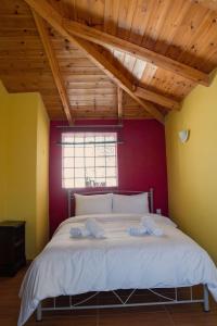 a bedroom with a large white bed in a room at Το Αρχοντικό της Λενιώς in Taxiárkhis