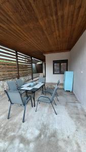 a patio with a table and chairs and a refrigerator at Casa Velvet in Potamiá