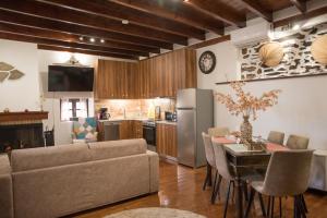 a kitchen and living room with a table and a refrigerator at Hope Nest Pelion in Zagora