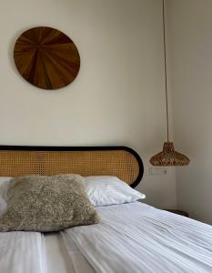 a bedroom with a bed with a wooden headboard at Domek Las&Luz Moszna BALIA in Moszna