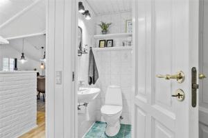 a white bathroom with a toilet and a sink at 0155-Romo-Davidstraede-10-c in Høm +15 photos