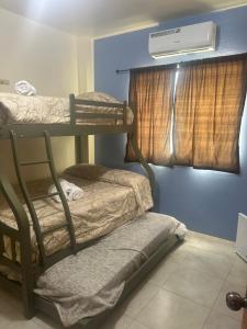 a room with two bunk beds and a window at Posada Estrella in Salinas +51 photos