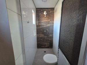 a bathroom with a toilet and a walk in shower at Hotel Faf's Interlagos - SP in São Paulo