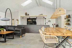 a dining room with a wooden table and chairs at 0364-Romo-Vestergardsvaenget-7 in Høm