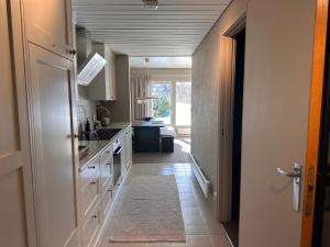 a kitchen with a sink and a counter at Leilighet på Hovden in Bykle +12 photos