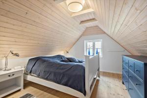 a bedroom with a bed and a wooden ceiling at 0123-Romo-Ivigtut-9 in Høm