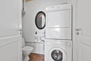 a bathroom with a washing machine and a sink at 0123-Romo-Ivigtut-9 in Høm +12 photos