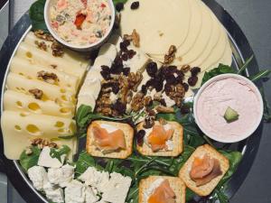 a plate of appetizers with cheese and other foods at Chateau D'Amour Luxury Boutique in Bucharest