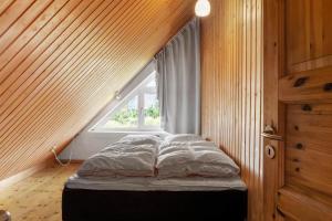 a small bed in a room with a window at 2005-Romo-Thadesvej-14 in Høm