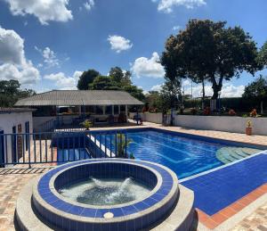a swimming pool with a fountain in the middle at Finca Tradicional La Rochela in Montenegro