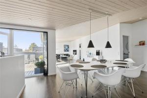 a kitchen and dining room with a table and chairs at 0323-Romo-Vestergade-359 in Høm +15 photos