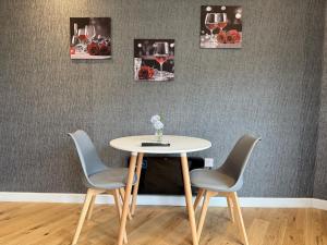 a table with two chairs and a table with wine glasses at Luxury studio in Bristol
