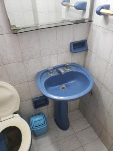 a bathroom with a blue sink and a toilet at DaKa in San Bernardo