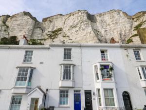 a bride standing on the roof of a house in front of cliffs at 7 Athol Terrace in Dover