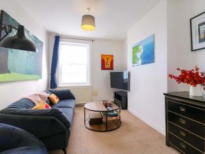 a living room with a couch and a table at 7 Athol Terrace in Dover