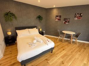 a bedroom with a bed with a table and chairs at Luxury studio in Bristol