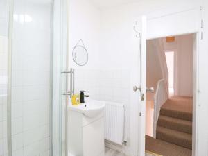 a white bathroom with a sink and a staircase at 7 Athol Terrace in Dover +28 photos