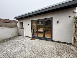 a building with large glass doors on a brick patio at Luxury studio in Bristol