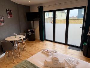 a room with a bed and a table and a table and chairs at Luxury studio in Bristol