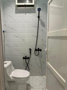 a white bathroom with a toilet and a shower at شقة اند هوم in Hail +9 photos