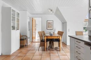 a kitchen with a table and chairs in a room at 2008-Romo-Froidal-10 in Høm