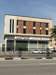 a building with a car parked in front of it at شقق الشموخ in Dammam