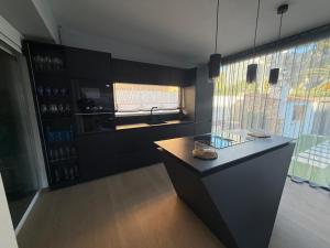 a kitchen with a counter and a large window at Evian Cala in Miami Platja