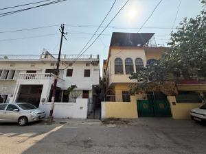 a building with a car parked in front of it at Nook Coliving Male Only in Lucknow