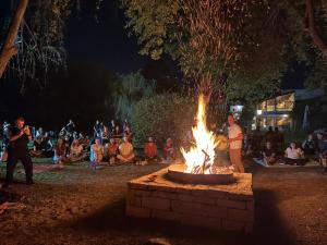 a fire pit with a crowd of people sitting around it at Sole Luna in Río Ceballos