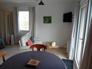 a living room with a table and a couch at domaine de marodi jasmin in Baignes-Sainte-Radegonde