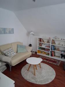 a living room with a couch and a table at Villa Siegrid in Kremsmünster