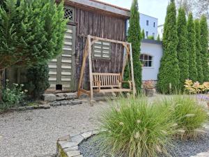 a garden with a bench in front of a building at Villa Siegrid in Kremsmünster