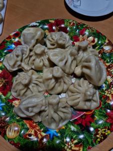 a plate of food on top of a christmas cake at Maia's Guesthouse in Mestia