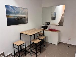 a kitchen with a table and stools and a microwave at Piata Uniri Cozy Inn in Bucharest +56 photos