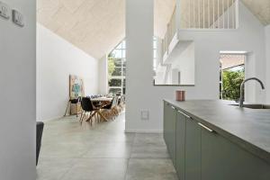 a kitchen with a counter and a dining room at 2007-Romo-Juvrevej-43 in Høm