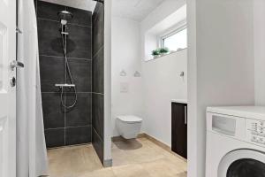 a bathroom with a shower with a toilet and a sink at 2007-Romo-Juvrevej-43 in Høm +23 photos