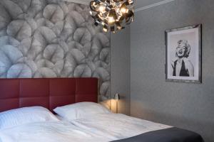 a bedroom with a large bed with a red headboard at Apartment Deichblick in Büsum