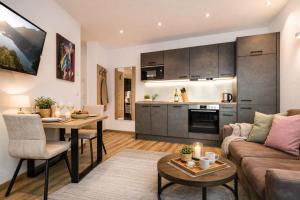 a living room with a couch and a table at Lechappart in Hofen +18 photos
