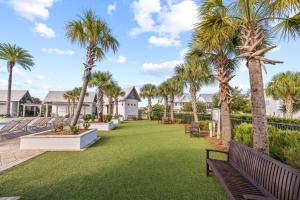a park with palm trees and benches at Isle be 'SEA'ing You in Inlet Beach