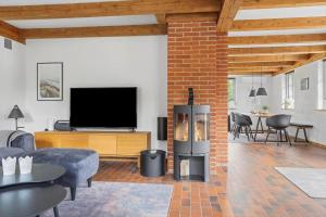 a living room with a fireplace and a television at 2805-Romo-A-Hveyselsvej-8 in Høm