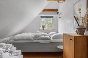 a bedroom with a bed and a window at 2805-Romo-A-Hveyselsvej-8 in Høm